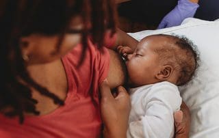 Woman learning how to breastfeed her baby