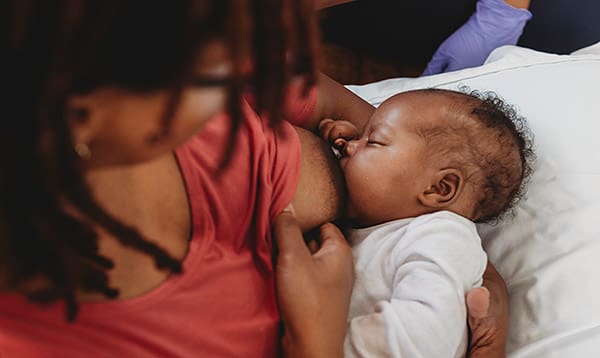 Woman learning how to breastfeed her baby