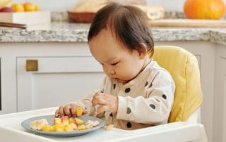 baby in highchair starting baby's first foods