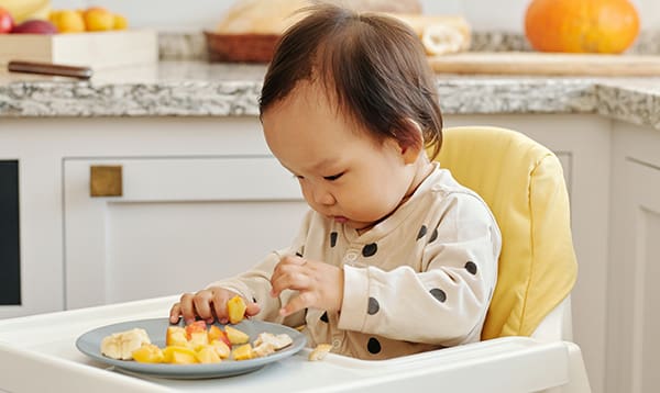 baby in highchair starting baby's first foods