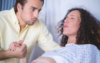 man being a birth partner to woman in labor