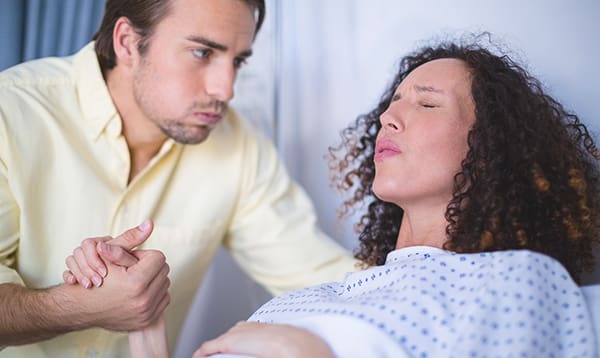 man being a birth partner to woman in labor