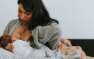 Mother having breastfeeding pain with her baby