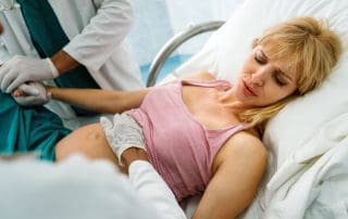 woman in labor getting cervical dilation check