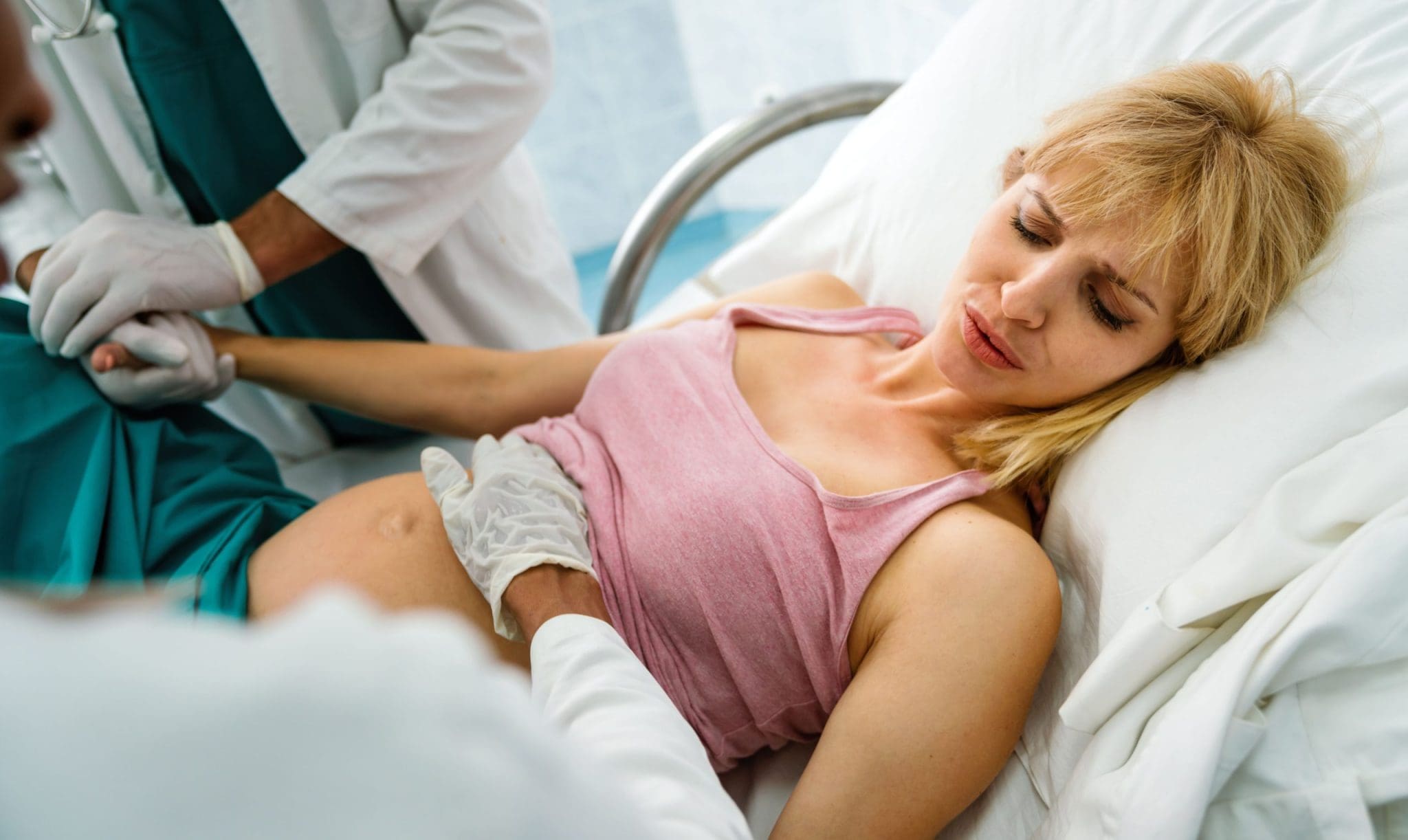 woman in labor getting cervical dilation check