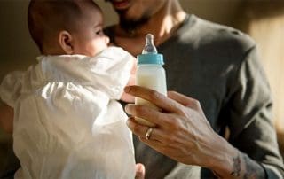 partner giving baby a bottle