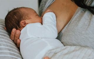 woman breastfeeding infant wanting to increase milk supply