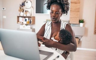 mother breastfeeding while working from home