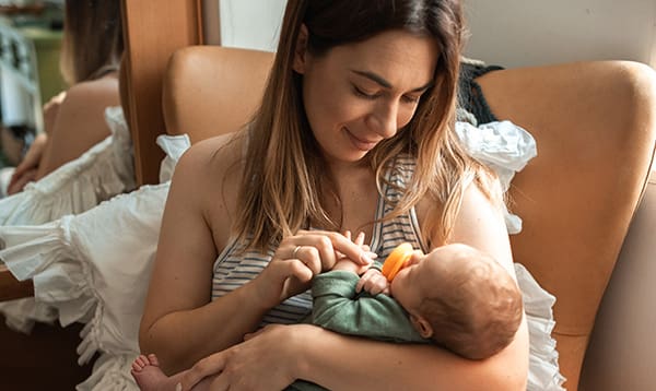 mother giving baby pacifier fearful of nipple confusion