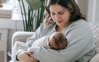 Woman with baby- breastfeeding vs nursing