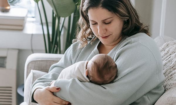 Woman with baby- breastfeeding vs nursing