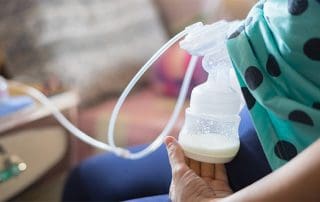 woman using a breast pump at work