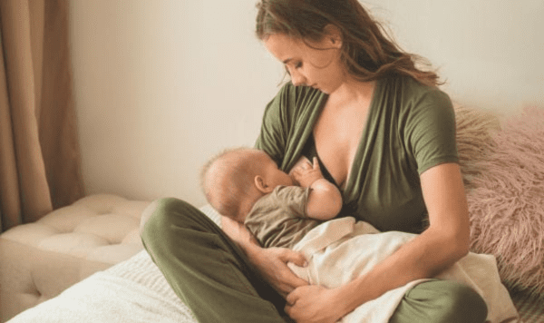 Mother breastfeeding her baby, showing cluster feeding.