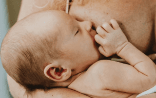 Baby being breastfed.