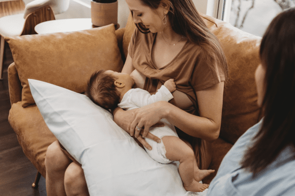 Breastfeeding Success' IBCLC helping a new mom with the cradle hold breastfeeding position